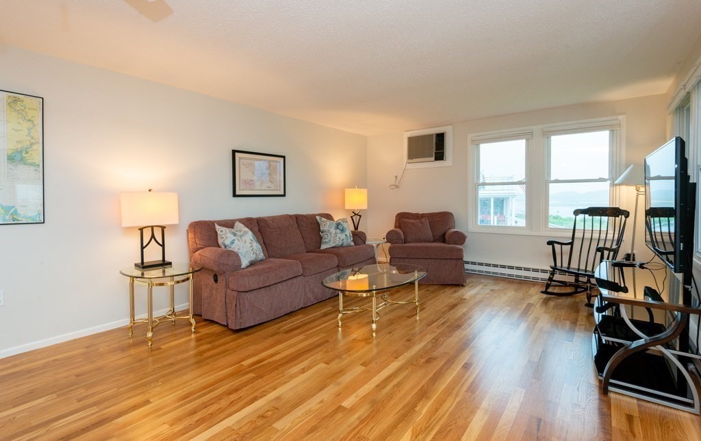 63 River Road Ipswich, MA 01938 - Photo 13 of 31 a living room with furniture and a flat screen tv
