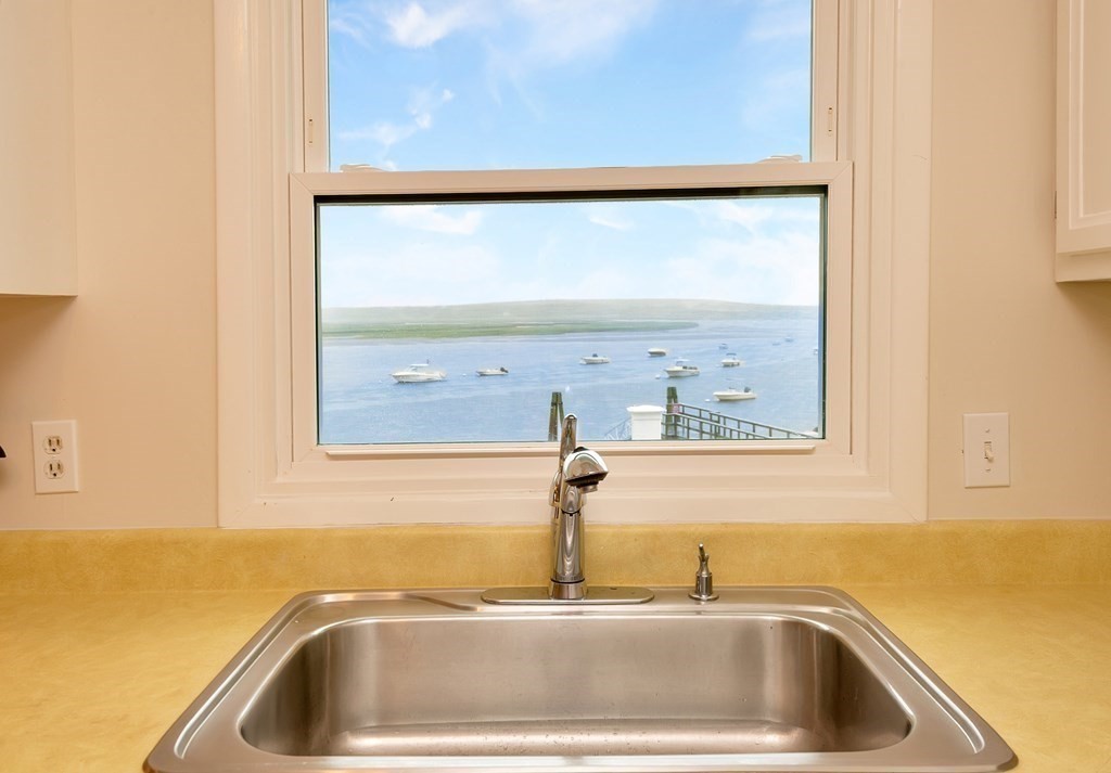 63 River Road Ipswich, MA 01938 - Photo 7 of 31 a bathroom with a sink and a window