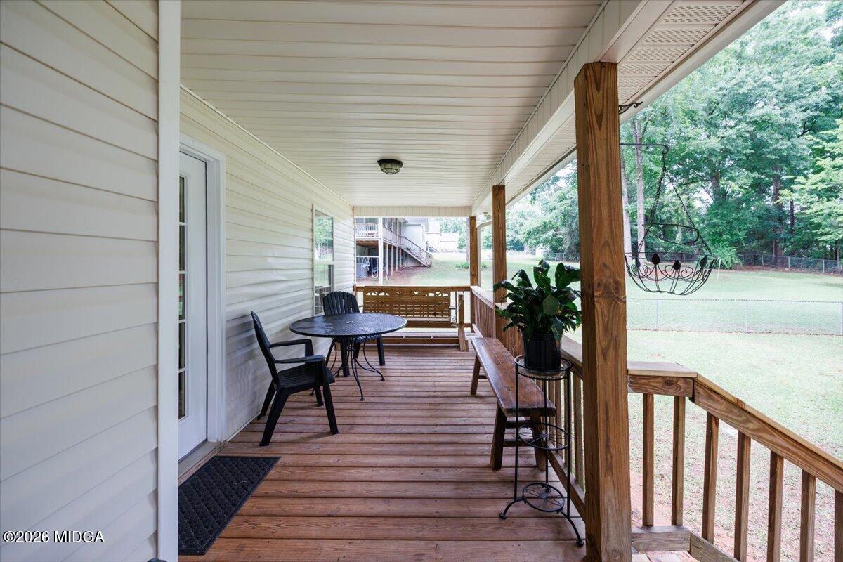 557 Aarons Circle Gray, GA 31032 - Photo 29 of 36 a view of a porch with chairs and potted plants