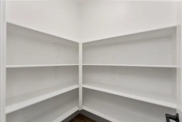 a view of walk in closet with empty racks