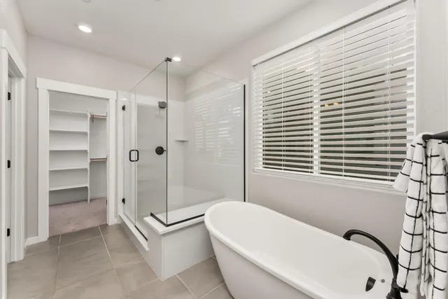 a bathroom with a bathtub and a shower