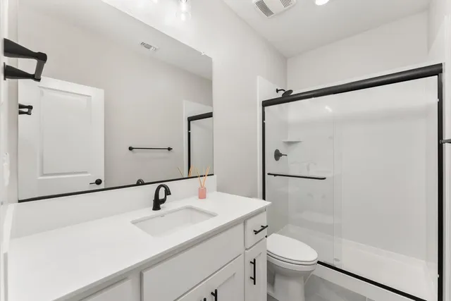 a bathroom with a sink toilet and shower
