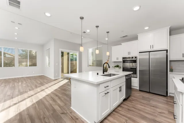 a kitchen with a sink refrigerator and microwave