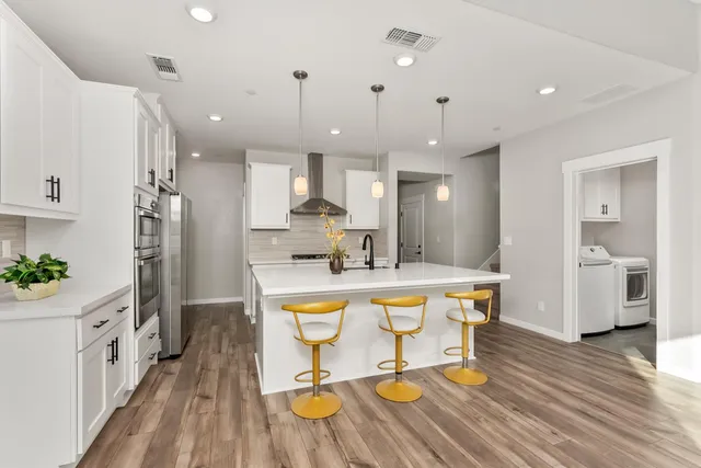 a large kitchen with a table and chairs in it