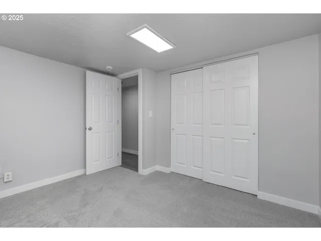 a view of an empty room and a window