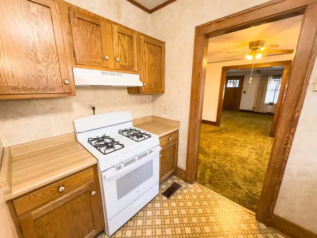 a kitchen with a stove a sink and a window