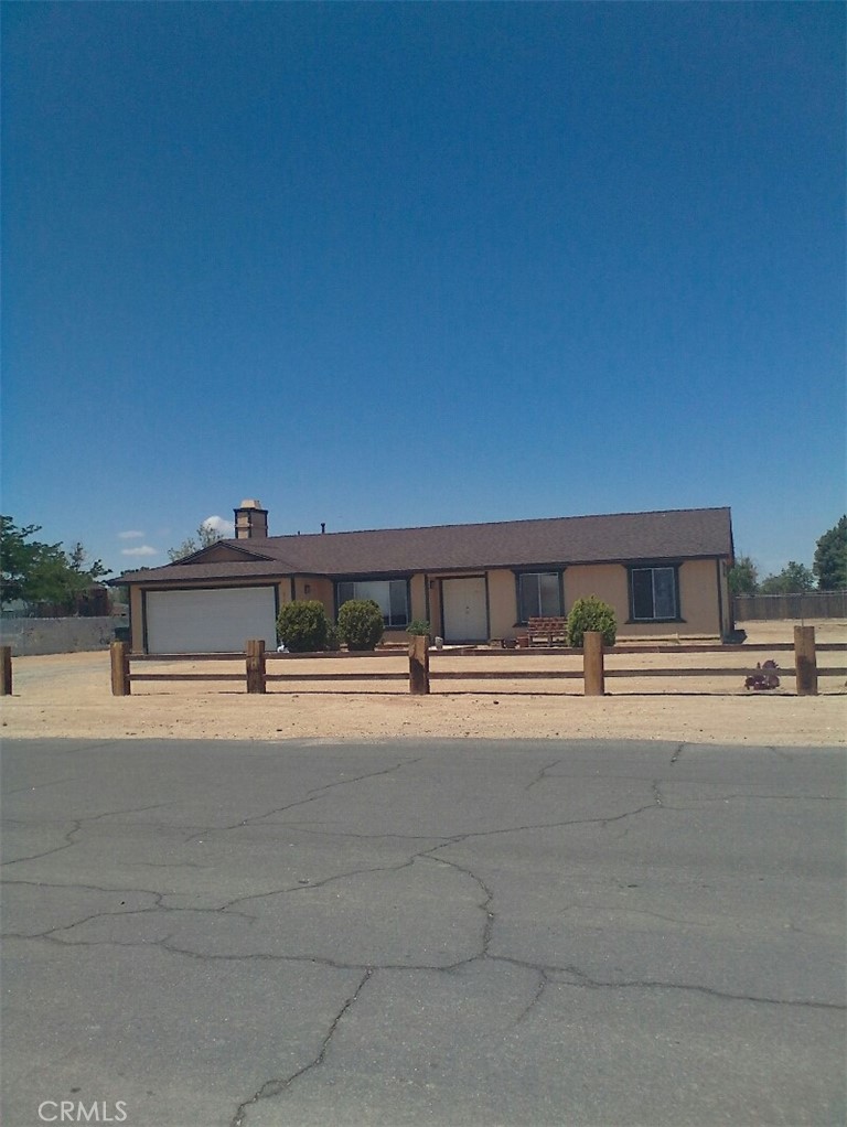 21036 Rambling Road Apple Valley, CA 92308 - Photo 1 of 1 a front view of a house with a yard and garage