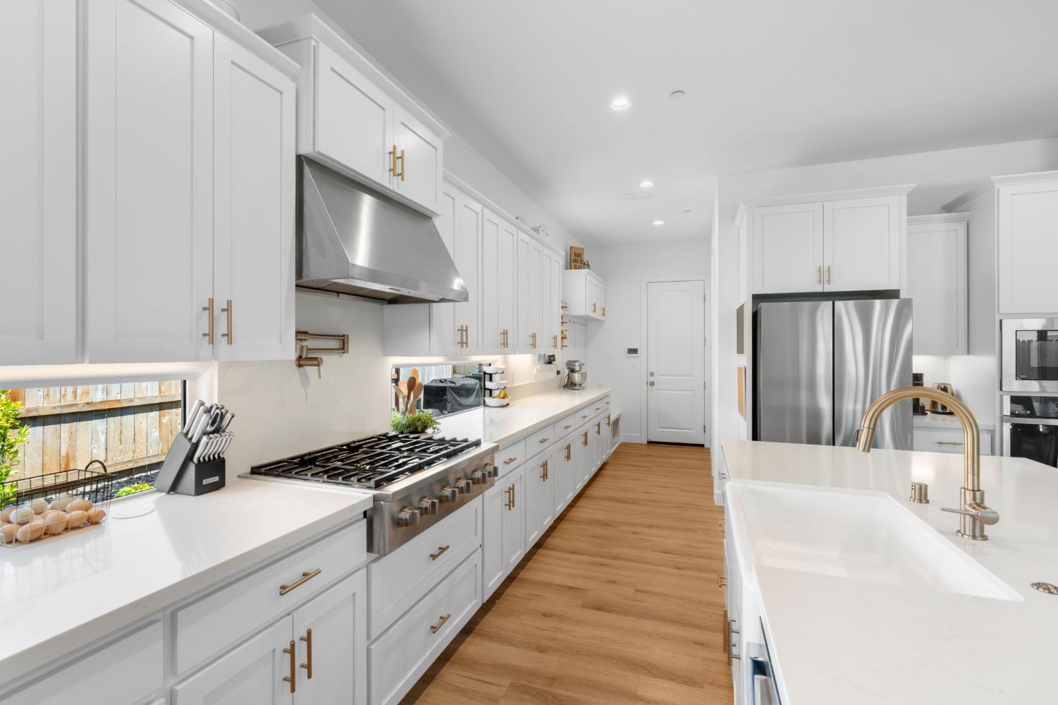 4314 Moro Cyn Street Rancho Cordova, CA 95742 - Photo 14 of 39 a large white kitchen with stainless steel appliances