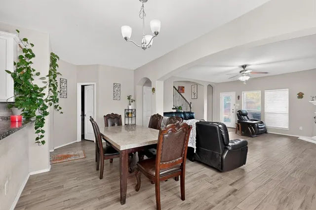 a view of a dining room with furniture and wooden floor