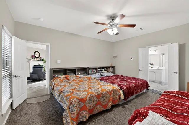 a bedroom with bed and a chandelier