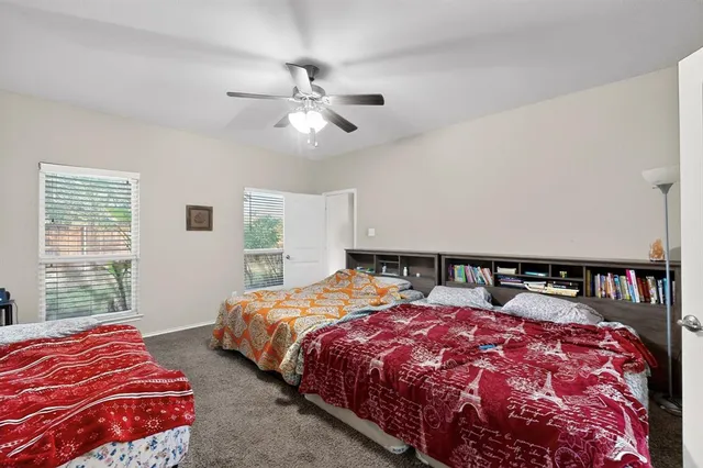 a bedroom with beds and a window