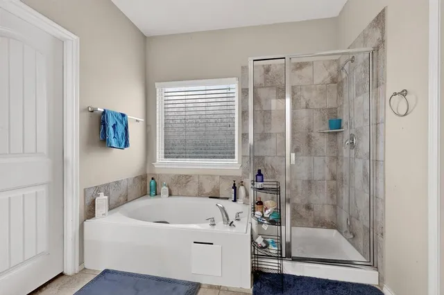 a white bath tub sitting next to a bathroom sink