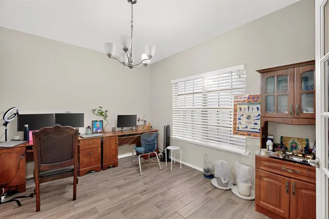 a view of a workspace with furniture and a window