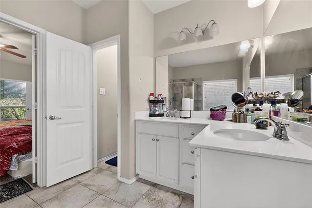 a bathroom with a sink vanity and a mirror