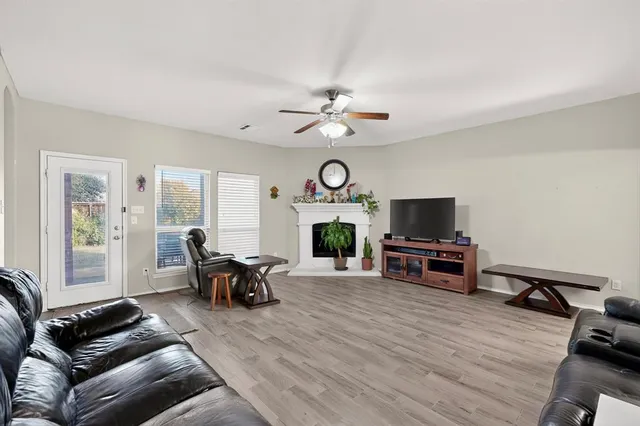 a living room with furniture a fireplace and a flat screen tv
