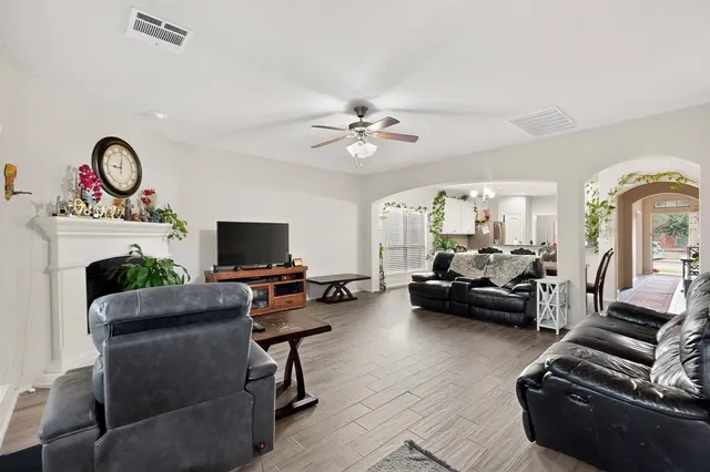 a living room with furniture a flat screen tv and a fireplace