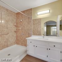 698 South Racetrack Road, Unit 412 Henderson, NV 89015 - Photo 15 of 25 Full bathroom with tiled shower, vanity, and wood finished floors