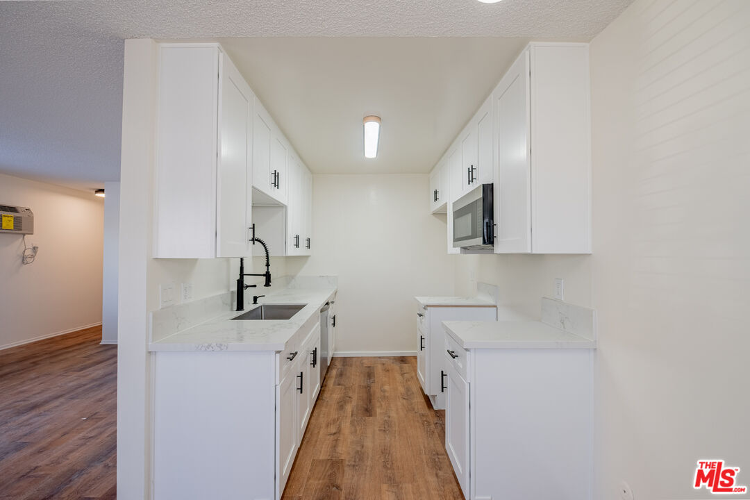 3826 Prospect Avenue, Unit 1 Culver City, CA 90232 - Photo 10 of 20 a kitchen with stainless steel appliances a sink stove and cabinets