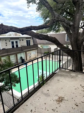 a view of a white house with a large window