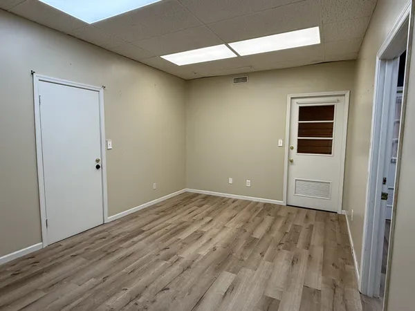 a view of an empty room with wooden floor
