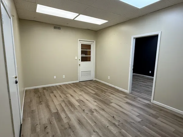 an empty room with wooden floor and closet