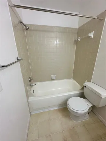 a bathroom with a toilet and a bathtub