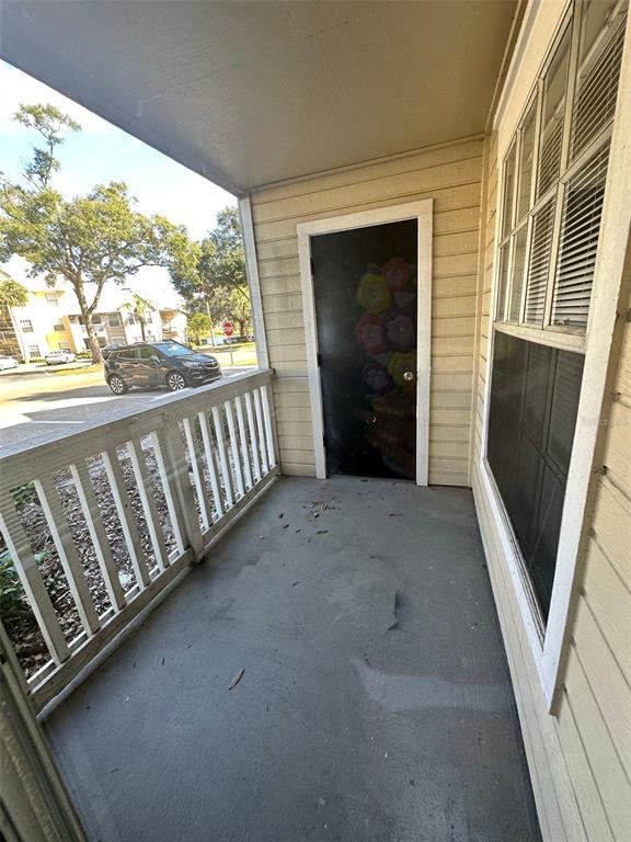 1063 South Hiawassee Road, Unit 1613 Orlando, FL 32835 - Photo 13 of 13 a view of a porch with wooden floor in front of a house