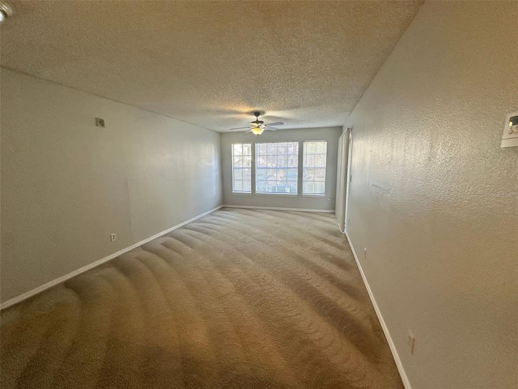 1063 South Hiawassee Road, Unit 1613 Orlando, FL 32835 - Photo 5 of 13 a view of an empty room with a window