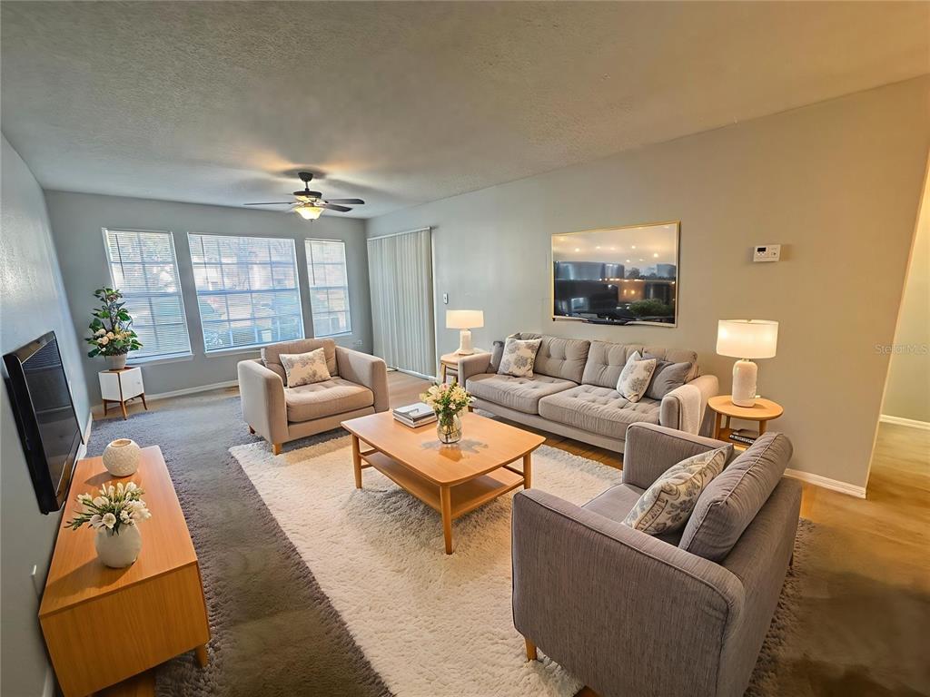 1063 South Hiawassee Road, Unit 1613 Orlando, FL 32835 - Photo 6 of 13 a living room with furniture and a flat screen tv