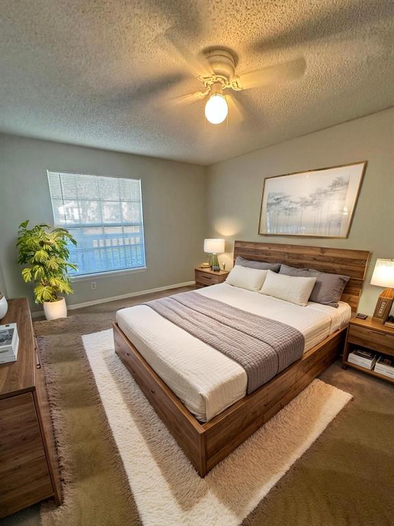 1063 South Hiawassee Road, Unit 1613 Orlando, FL 32835 - Photo 9 of 13 a bedroom with a bed and a chandelier