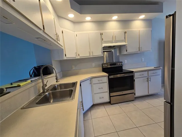 a kitchen with a sink cabinets and appliances
