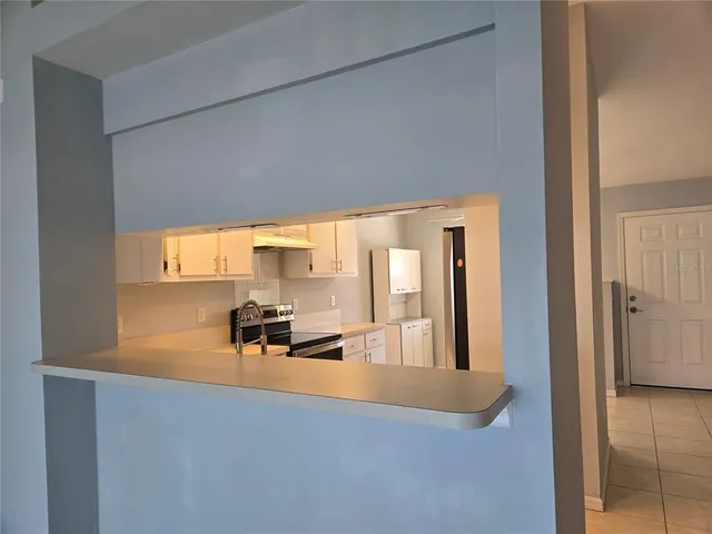 a living room with furniture and large windows