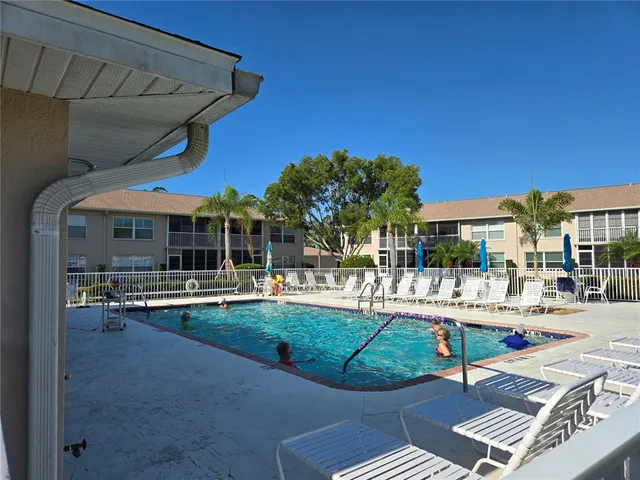 a view of a patio with a table and chairs under an umbrella