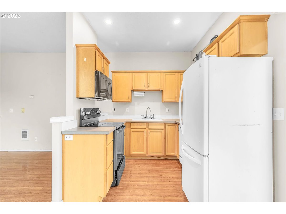 34970 Burt Road St. Helens, OR 97051 - Photo 12 of 33 a kitchen with stainless steel appliances granite countertop a sink a stove a refrigerator with grey cabinets