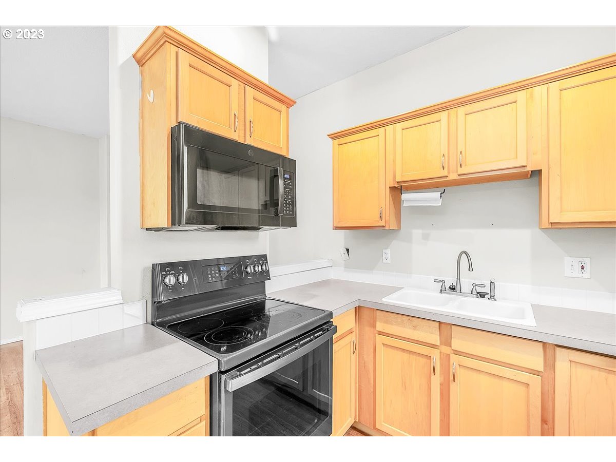 34970 Burt Road St. Helens, OR 97051 - Photo 14 of 33 a kitchen with granite countertop a sink a stove top oven and cabinetry