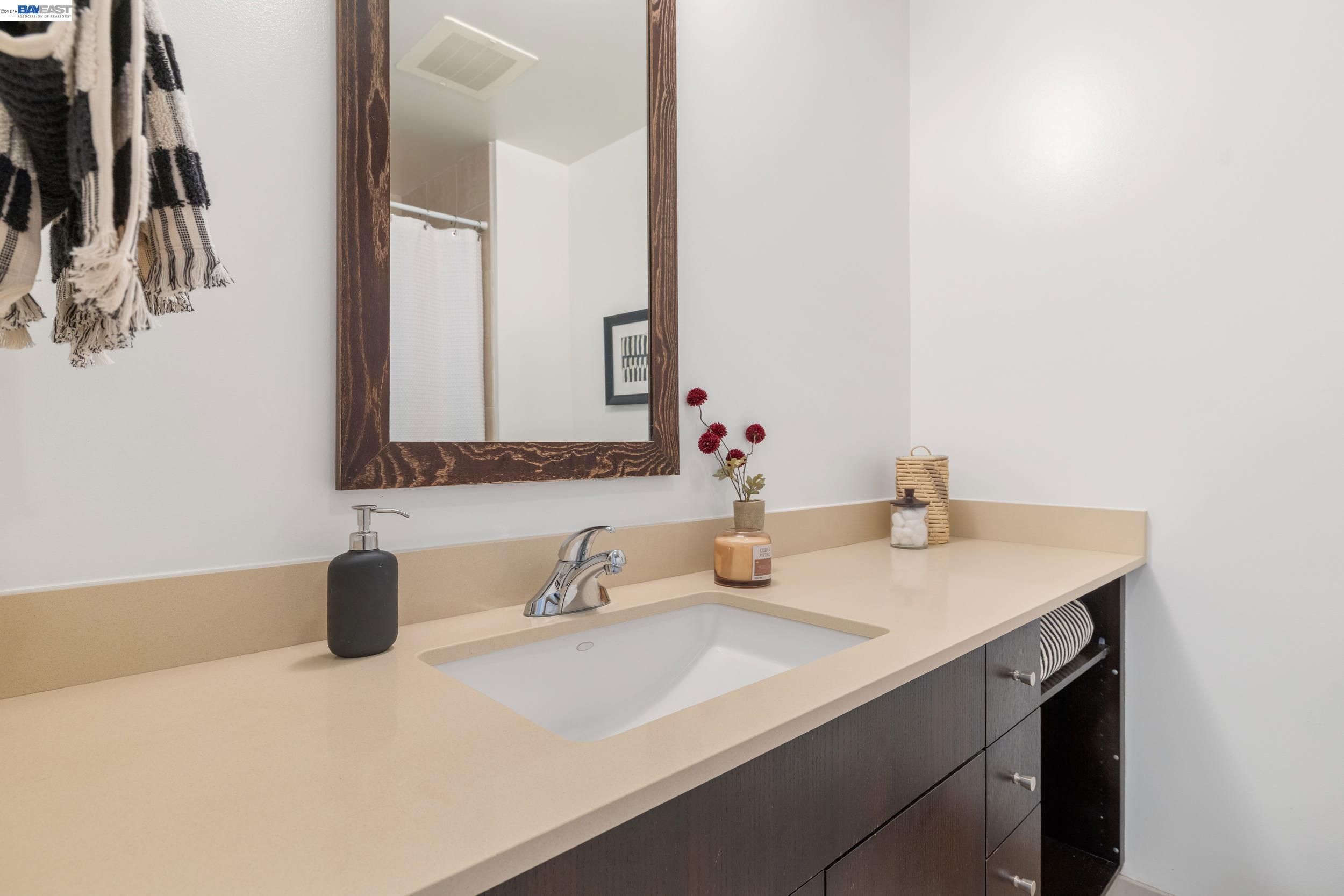 585 Ninth Street, Unit 443 Oakland, CA 94607 - Photo 18 of 32 a bathroom with a sink and a mirror