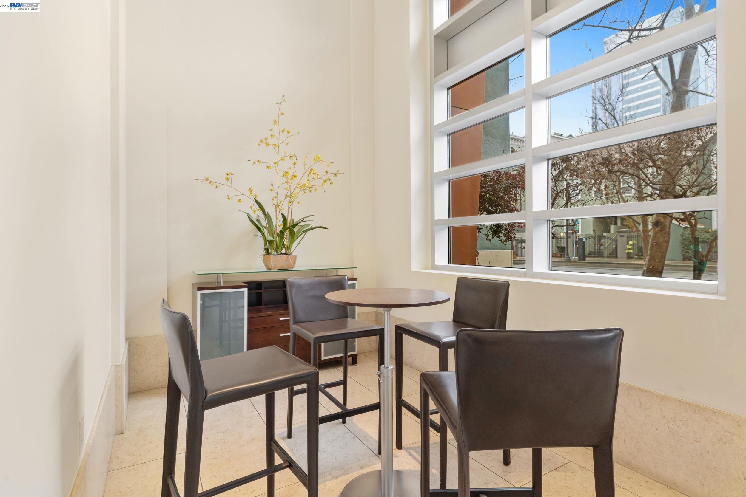 585 Ninth Street, Unit 443 Oakland, CA 94607 - Photo 22 of 32 a view of a dining room with furniture and a potted plant