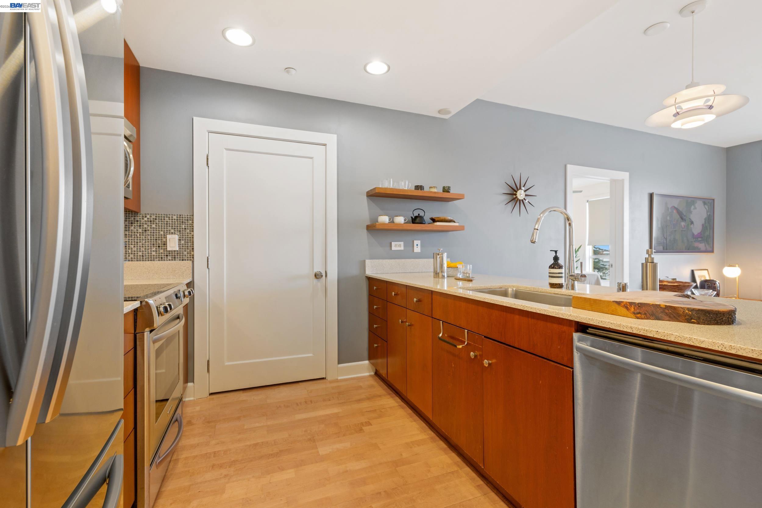 585 Ninth Street, Unit 443 Oakland, CA 94607 - Photo 6 of 32 a room with a sink and a refrigerator