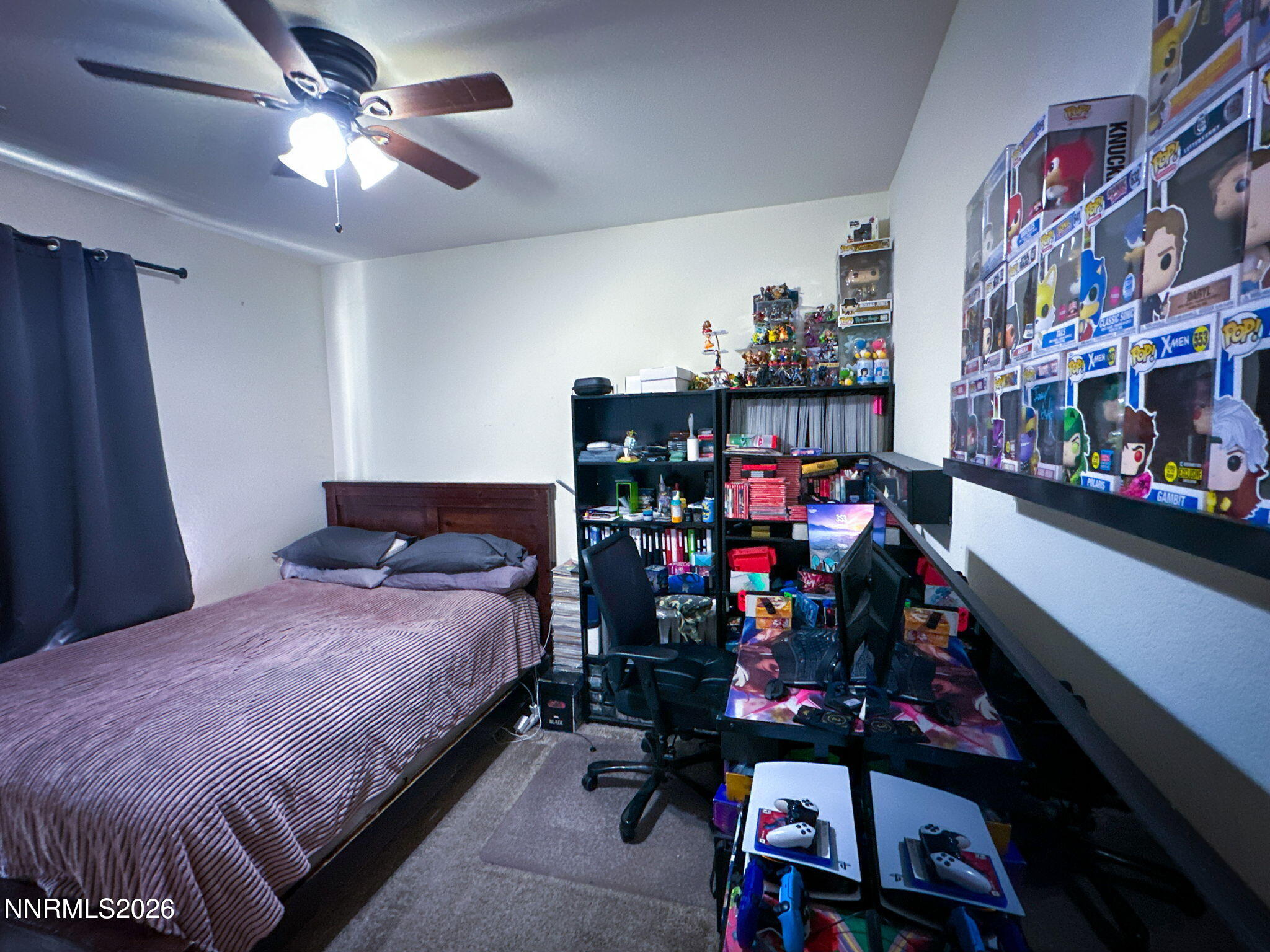 7330 Overture Drive Reno, NV 89506 - Photo 14 of 17 a bedroom with bed and a chandelier
