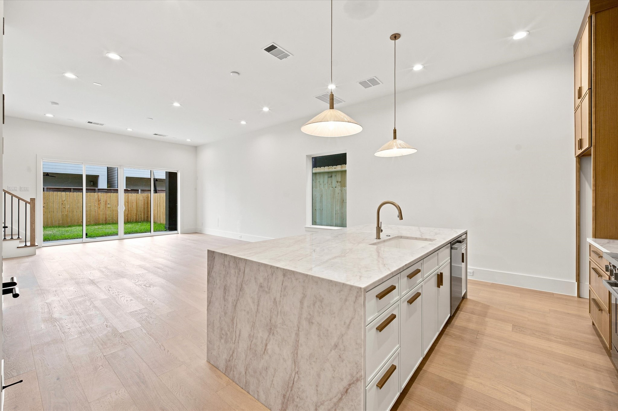 112 East 27th Street Houston, TX 77008 - Photo 8 of 43 The quartz waterfall island anchors the chef's kitchen, which opens seamlessly to the living and dining areas for effortless everyday living and entertaining.