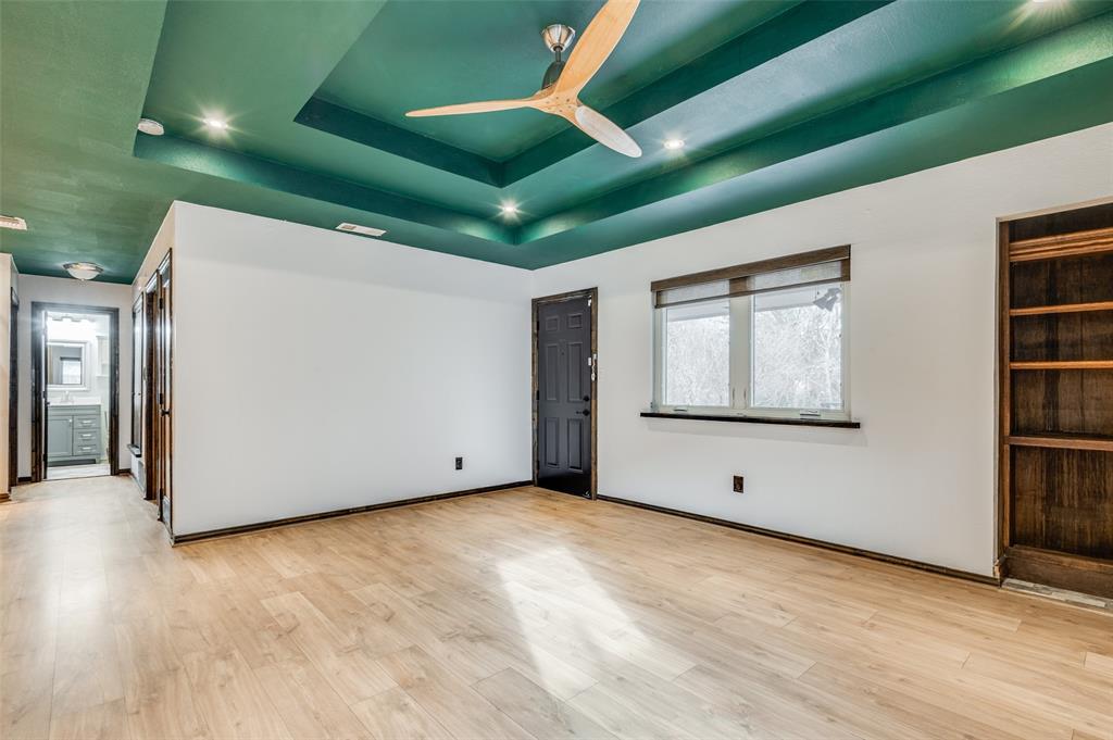 2749 Buna Drive Dallas, TX 75211 - Photo 6 of 12 Living room with a tray ceiling, light wood-style flooring, ceiling fan, and recessed lighting