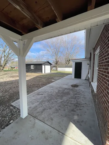 a view of an empty room with a sink and a window