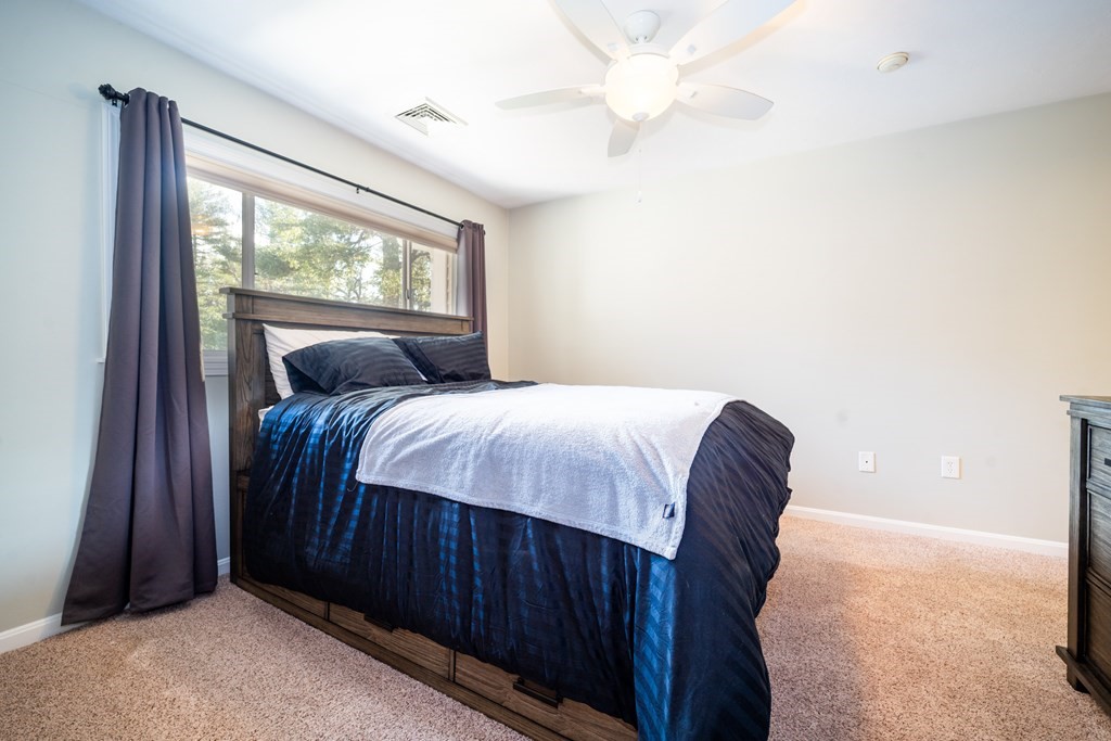 750 Whittenton Street, Unit 523 Taunton, MA 02780 - Photo 15 of 37 a bedroom with a large bed and a large window