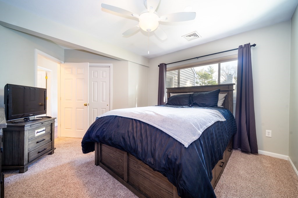 750 Whittenton Street, Unit 523 Taunton, MA 02780 - Photo 16 of 37 a bedroom with a bed and a flat tv screen on dresser