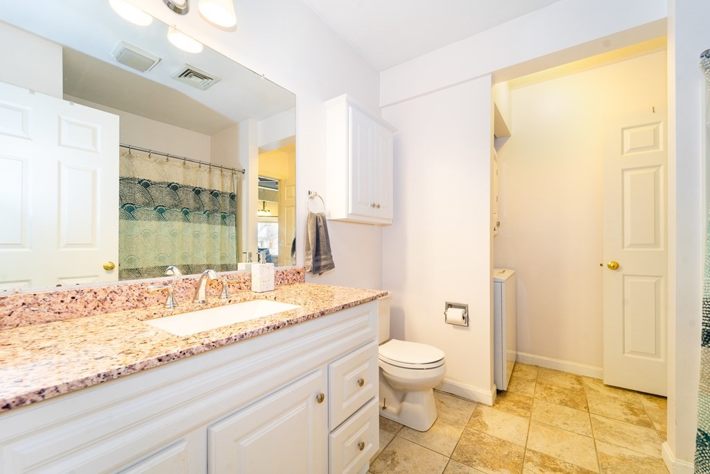 750 Whittenton Street, Unit 523 Taunton, MA 02780 - Photo 18 of 37 a bathroom with a granite countertop sink toilet and shower