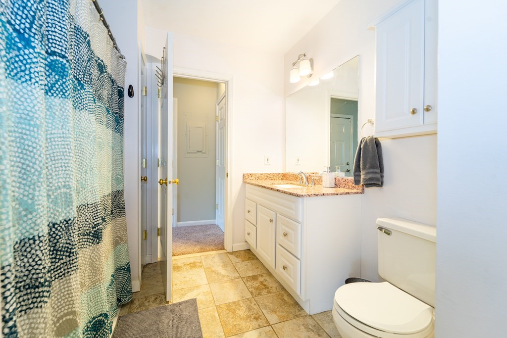 750 Whittenton Street, Unit 523 Taunton, MA 02780 - Photo 19 of 37 a bathroom with a granite countertop sink toilet and shower