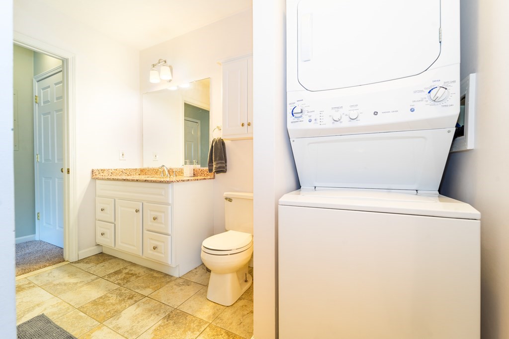 750 Whittenton Street, Unit 523 Taunton, MA 02780 - Photo 20 of 37 a bathroom with a granite countertop toilet sink and mirror