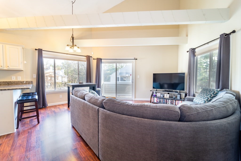 750 Whittenton Street, Unit 523 Taunton, MA 02780 - Photo 10 of 37 a living room with furniture and a flat screen tv