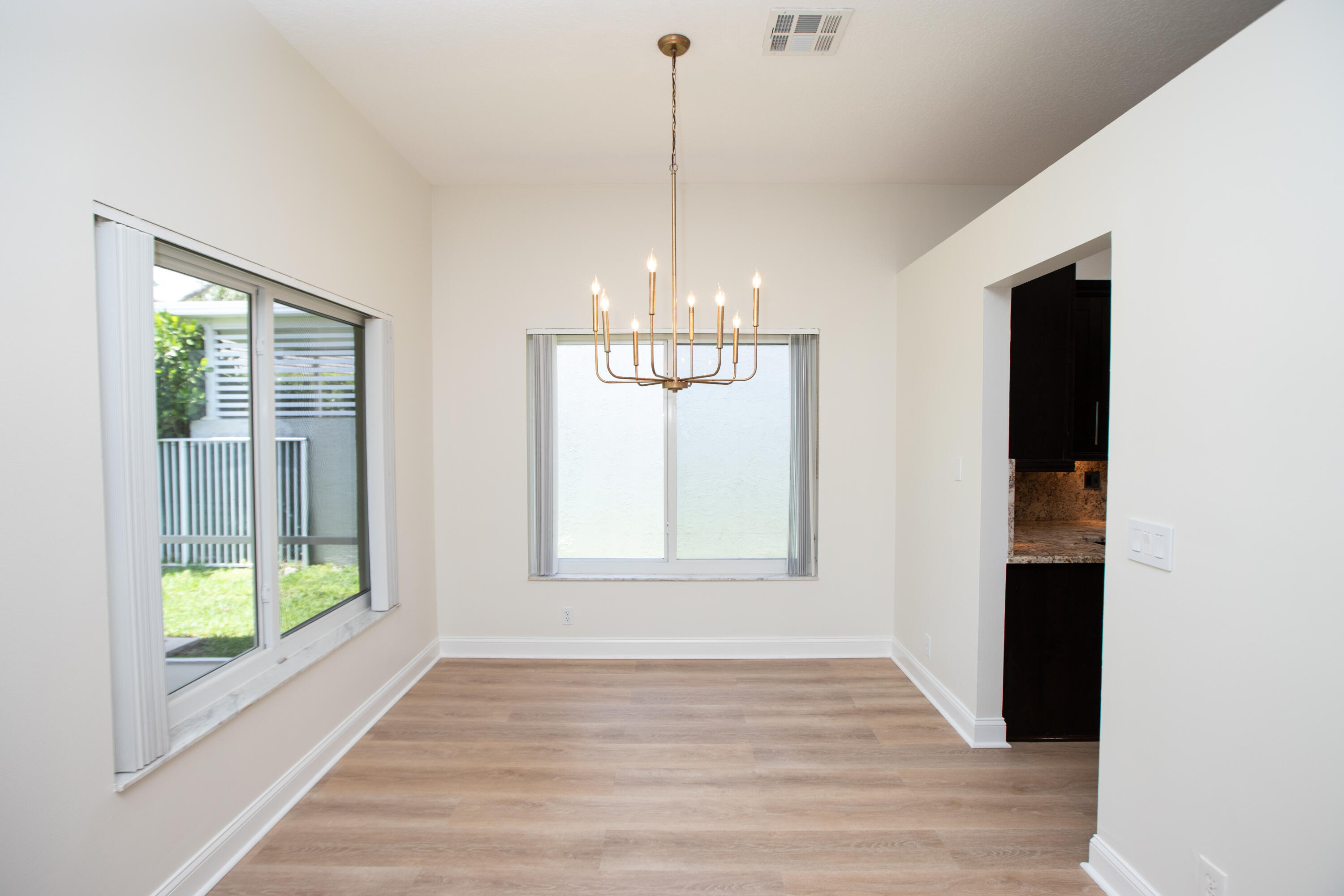 10821 La Salinas Circle Boca Raton, FL 33428 - Photo 11 of 64 a view of an empty room with wooden floor and a window