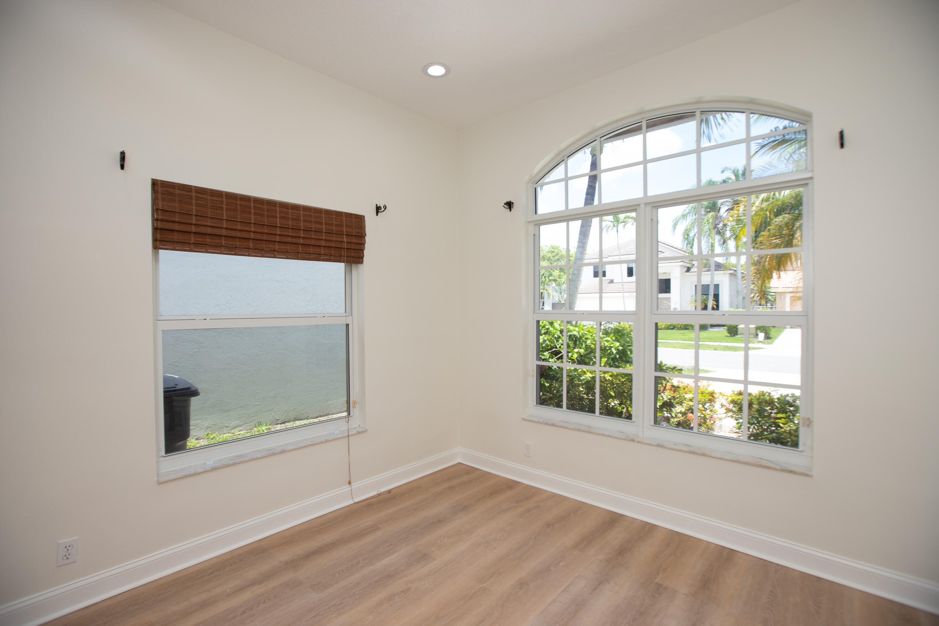 10821 La Salinas Circle Boca Raton, FL 33428 - Photo 13 of 64 an empty room with wooden floor and windows
